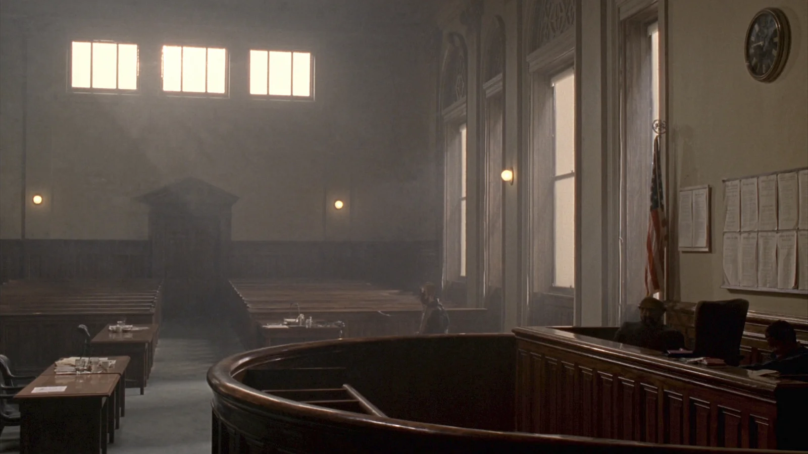 An empty American courtroom with vacant public benches and counsel tables