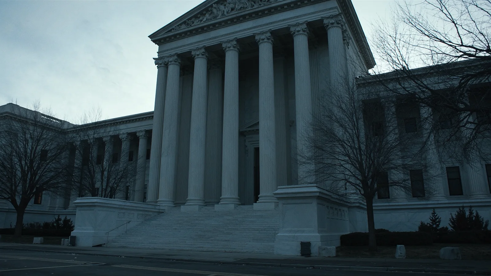 The marble columns and empty steps of a neoclassical supreme court building at dawn